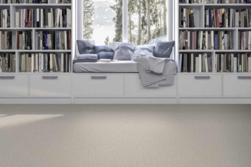 off-white patterned carpet in library with window reading nook facing winter scenery